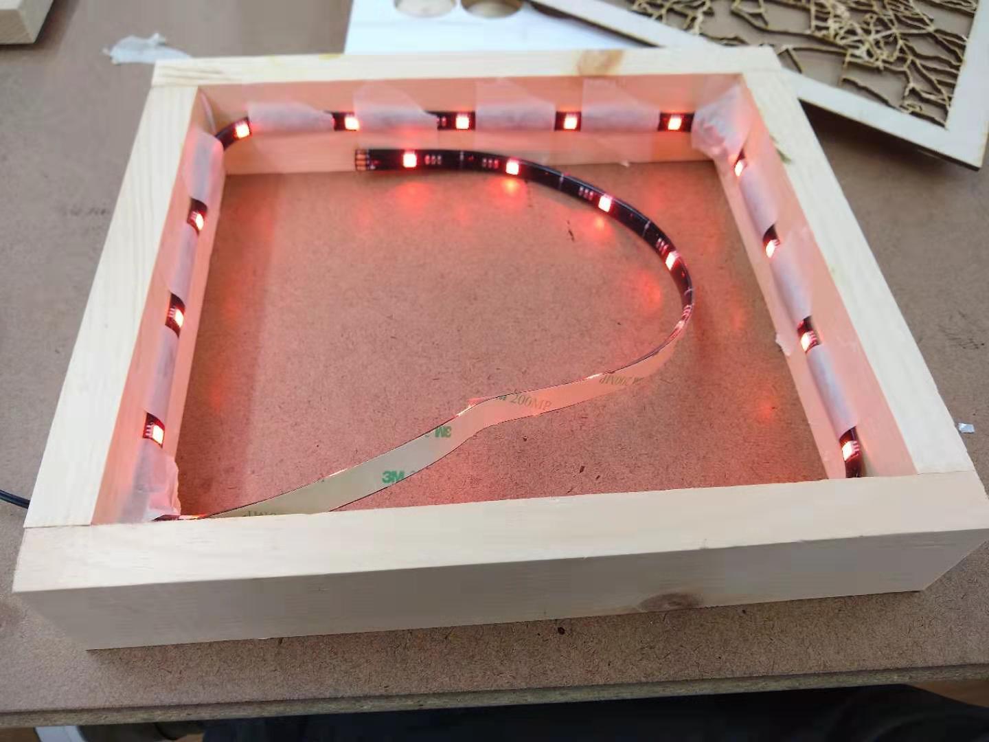 A box frame with LEDs taped to the inside.