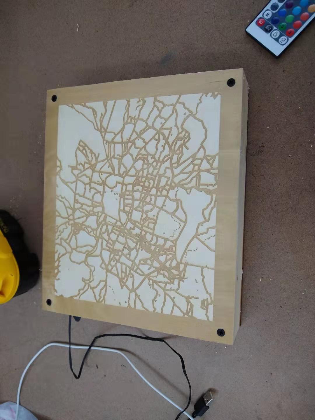 A box with an engraved city map screwed on the back.
