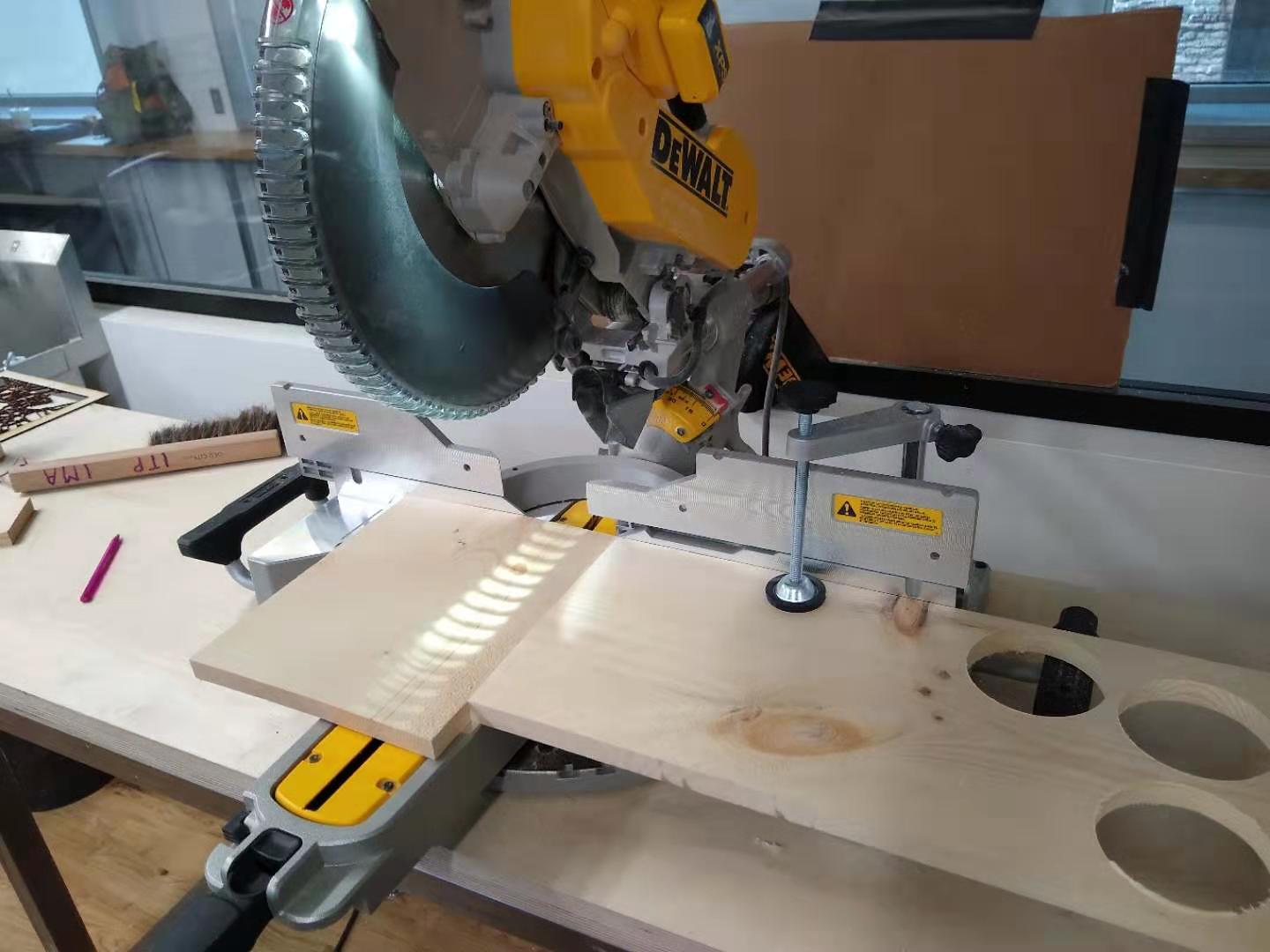 A piece of wood under the miter saw.