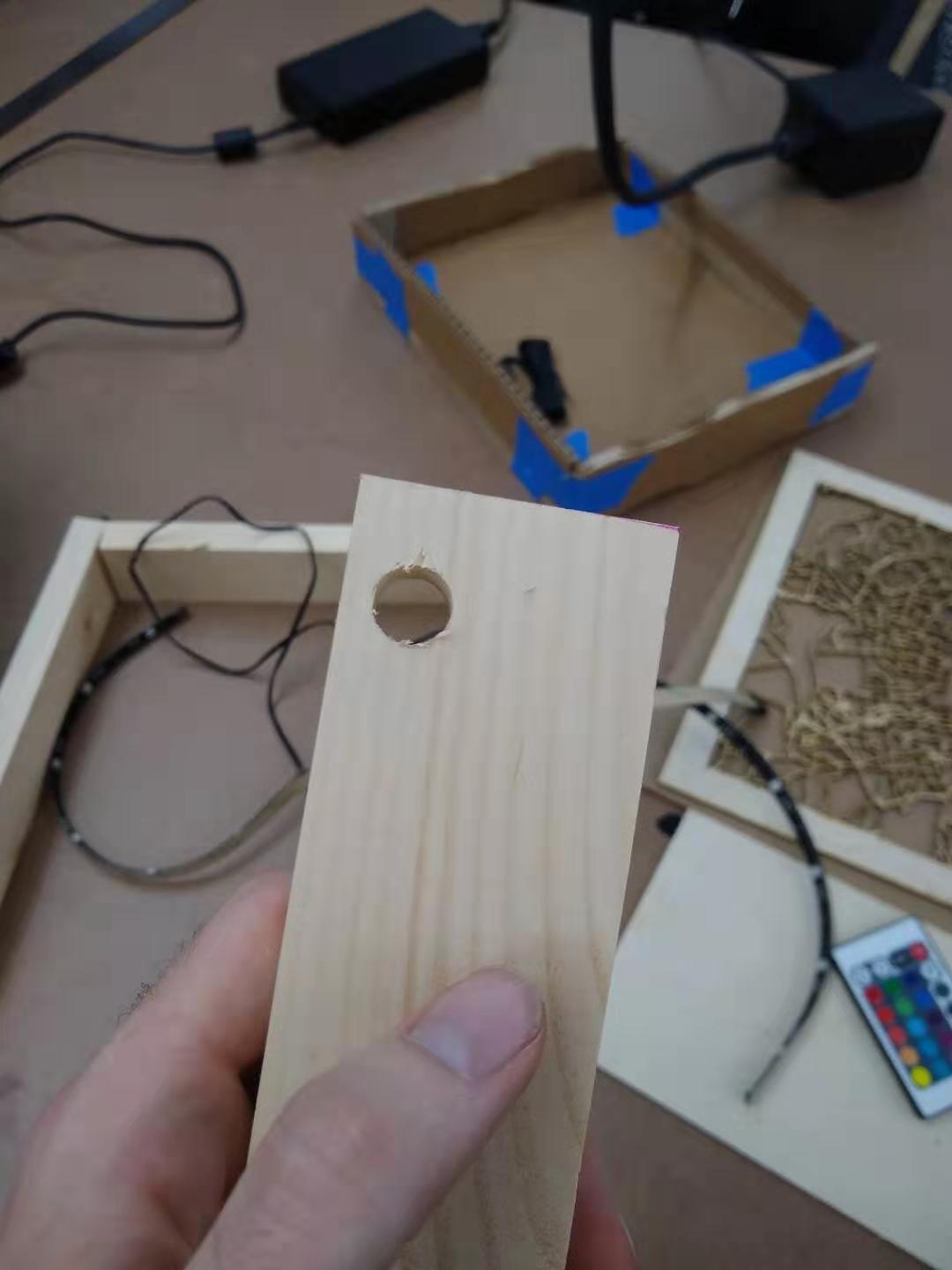 A piece of wood with a half-inch hole drilled through.