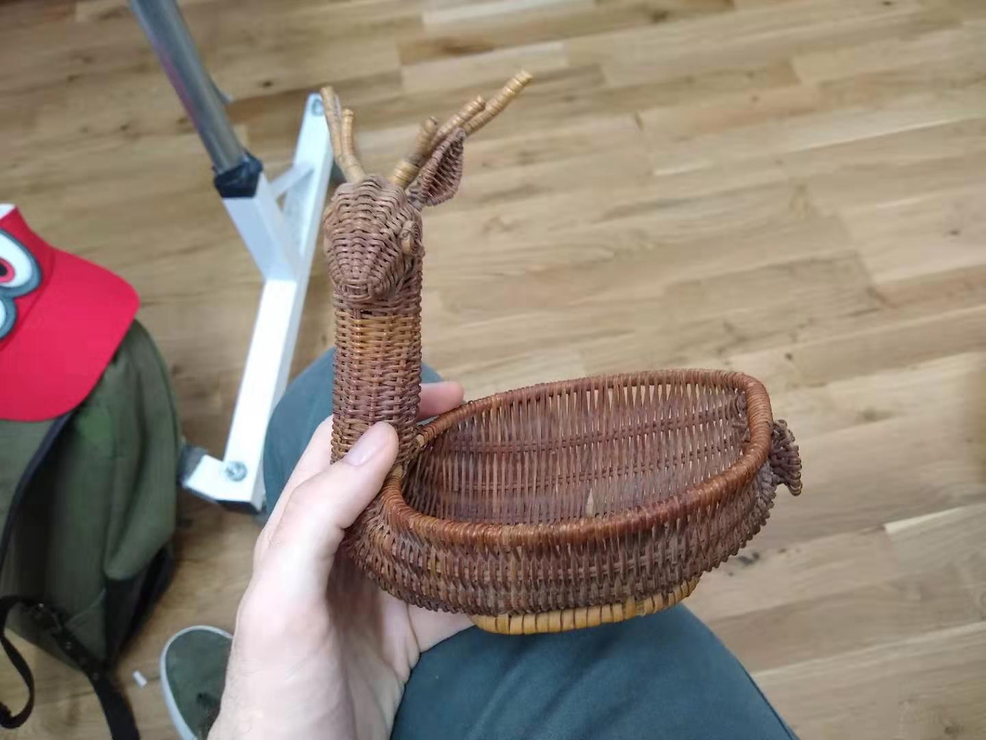 A wicker deer with one eye and ear missing.
