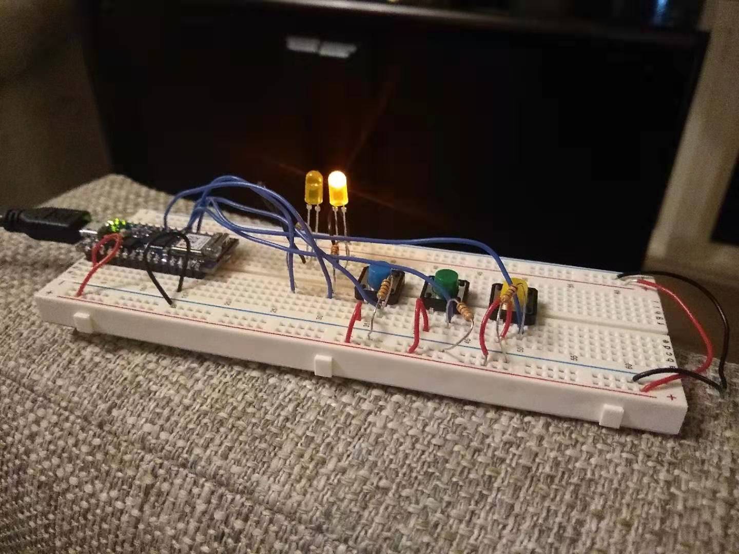 A photo of an LED lit  up on a breadboard.
