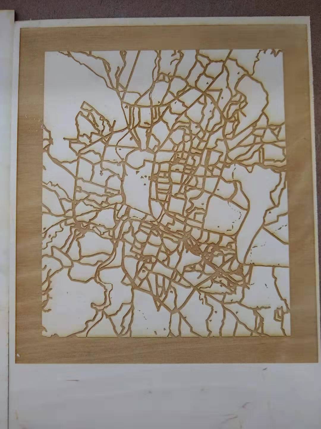 A city map etched onto wood.