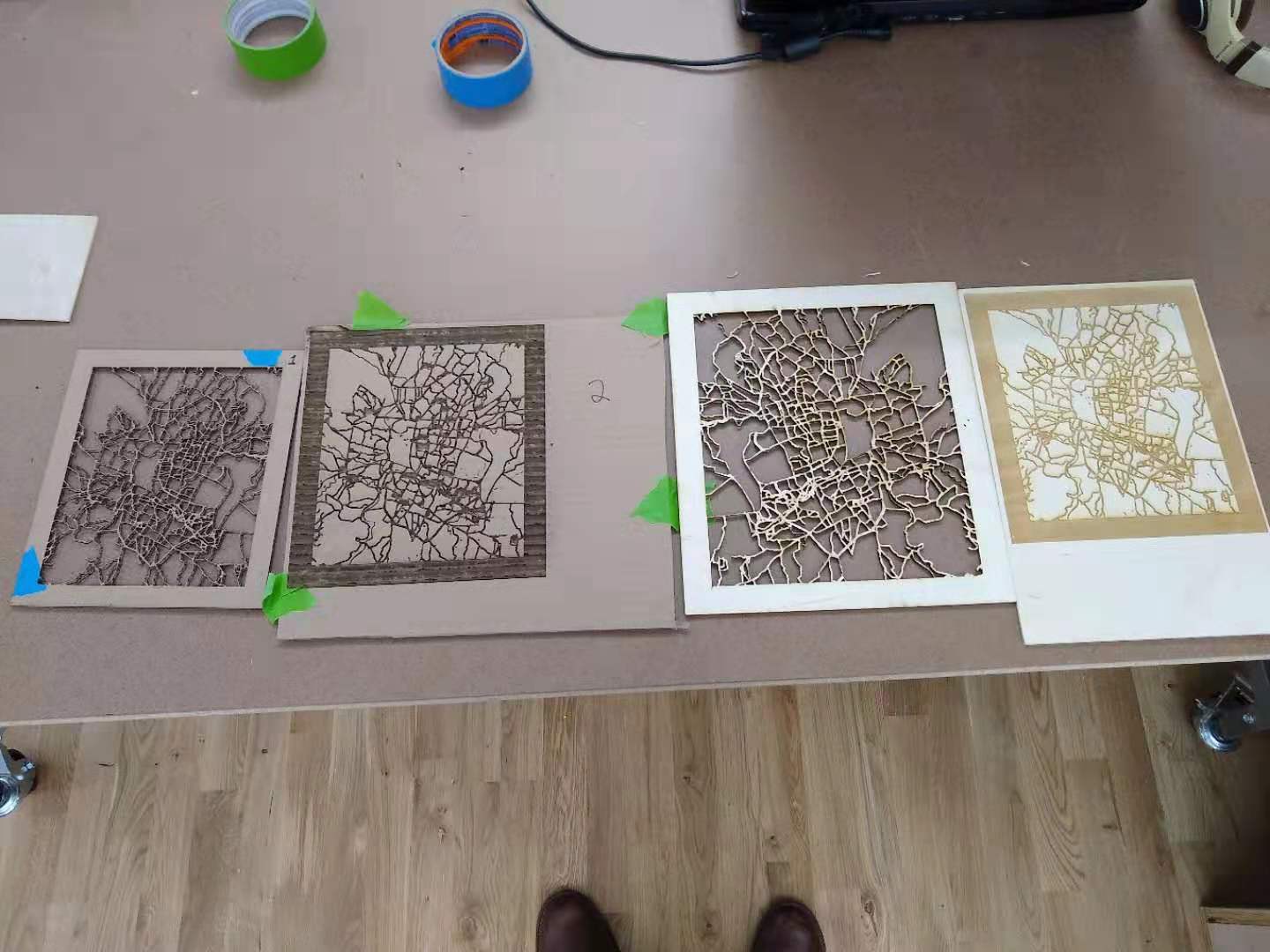 Four etched and cut cities next to each other.
