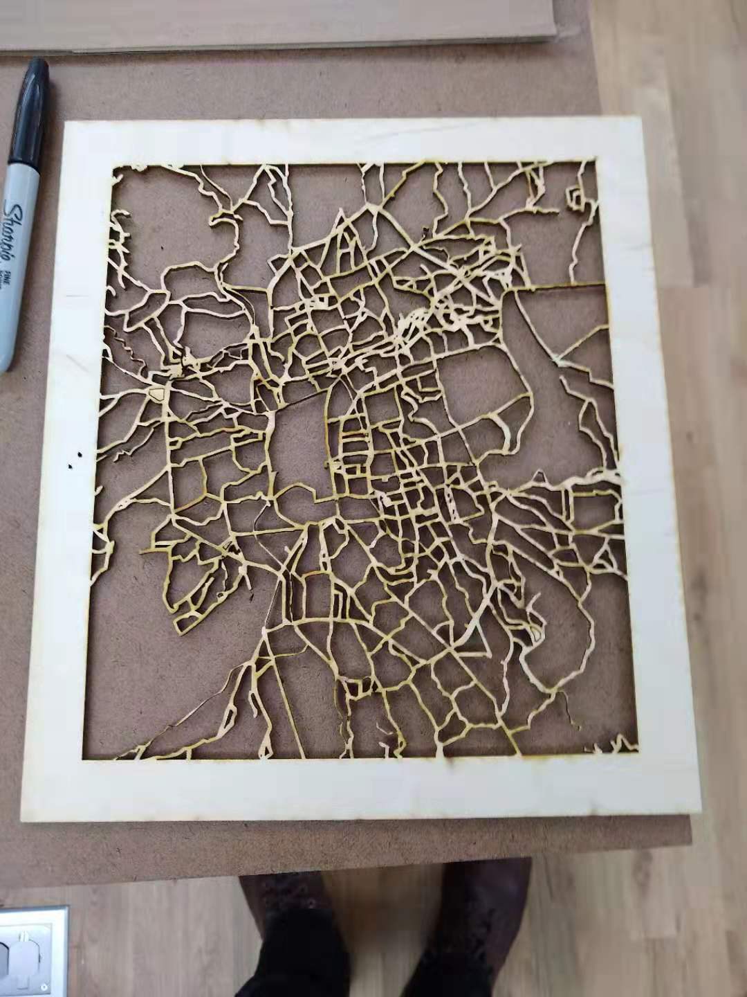 A city map cut from wood.