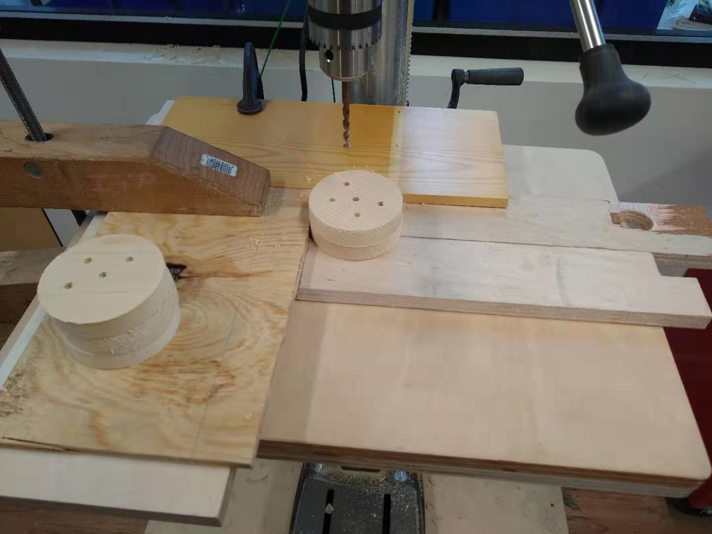 A picture of one of my smileys on top of another
    on the drill press, with the holes aligned.